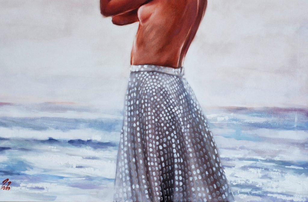 Detail of dotted light skirt against soft sea and shoreline tones