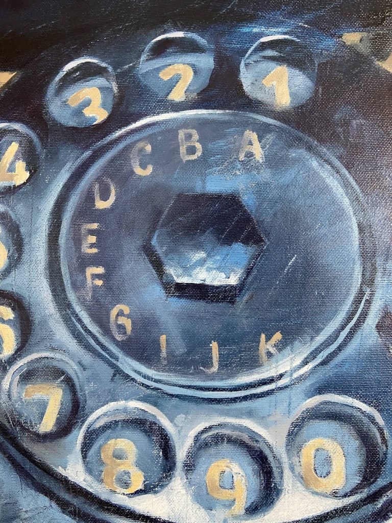 Circular dial with golden numerals on vintage phone