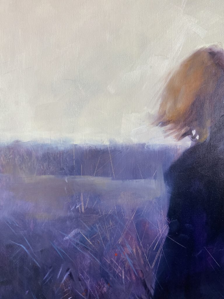 Person standing in a field, looking around in confusion