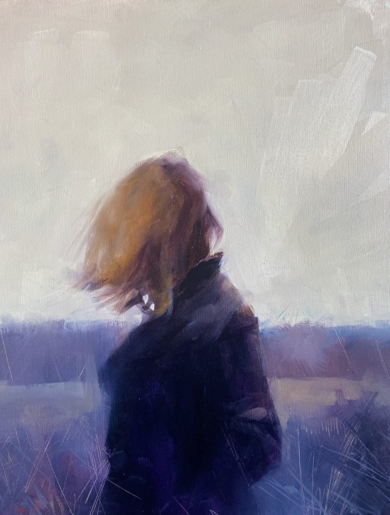 Person sitting in a field, reflecting on the strangeness of the place