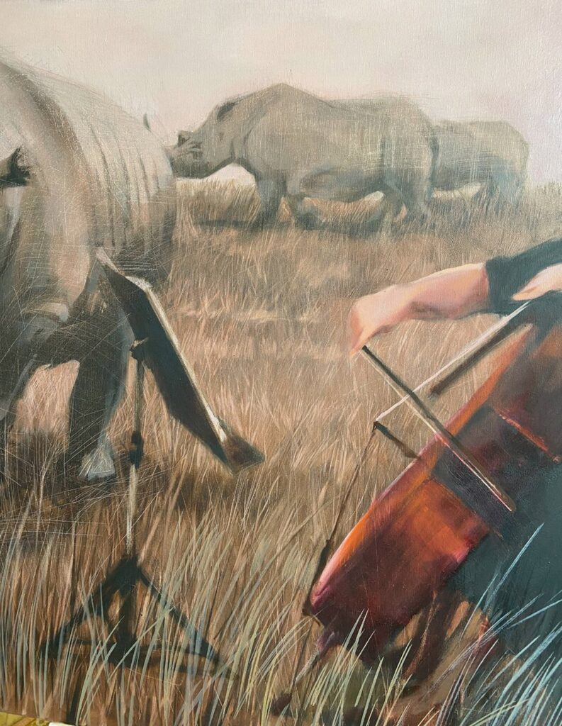 Cellist hands holding bow against cello strings