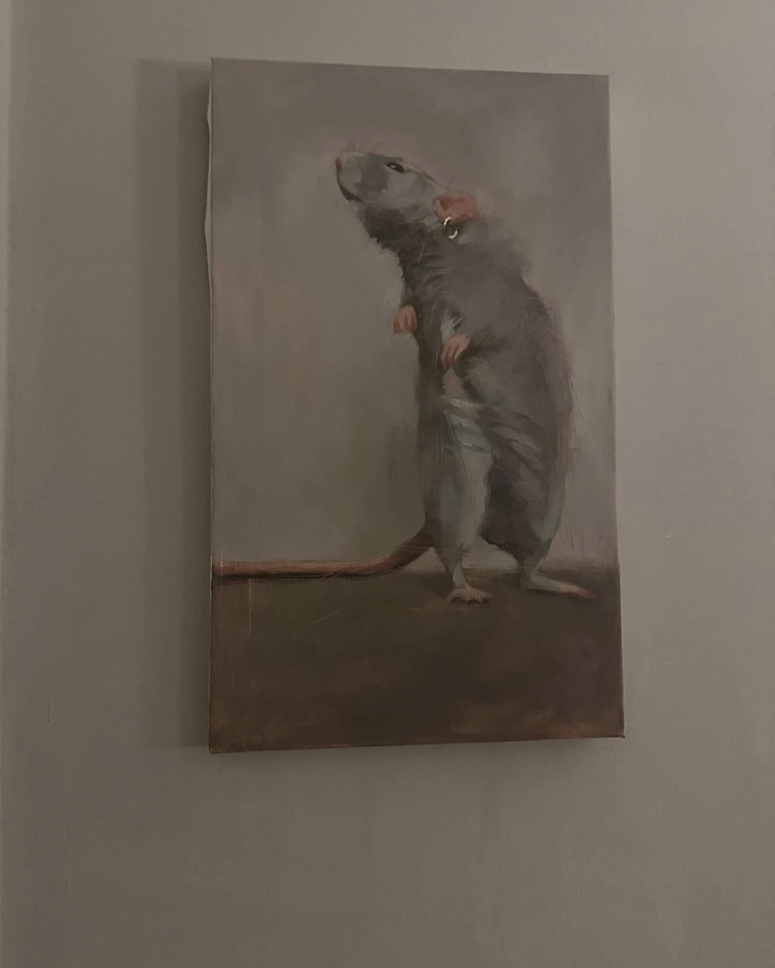 Christmas Rat oil painting by Igor Shulman, 2024, shown framed and hanging on a wall in a cozy interior setting