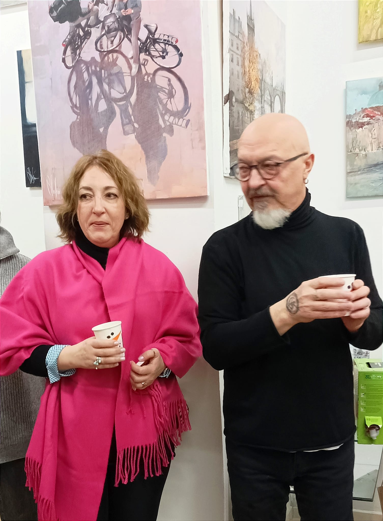 Igor Shulman and Tatiana standing near "Meeting after Work" painting at ART Gallery 11 Prague