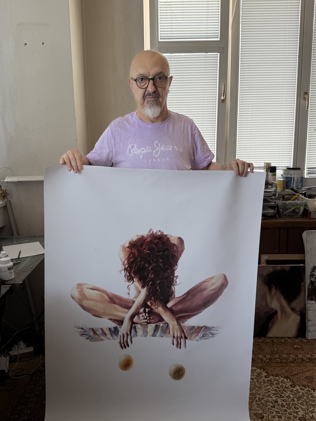 Igor Shulman holds a printed on canvas artwork named Deep Meditation