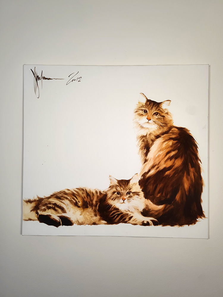 Cats by Igor Shulman displayed on a wall for scale